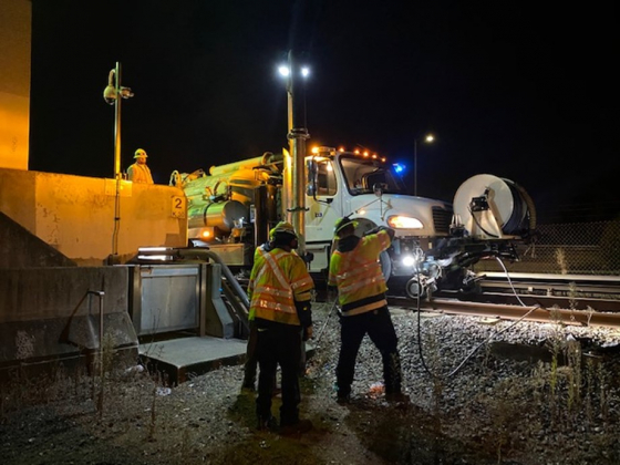 Three men working at night on site of a miscellaneous BART civil support project