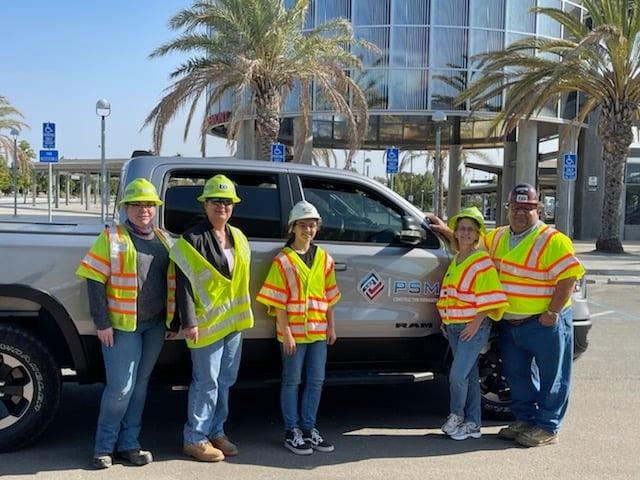 PSM Associates team standing in front of a work truck